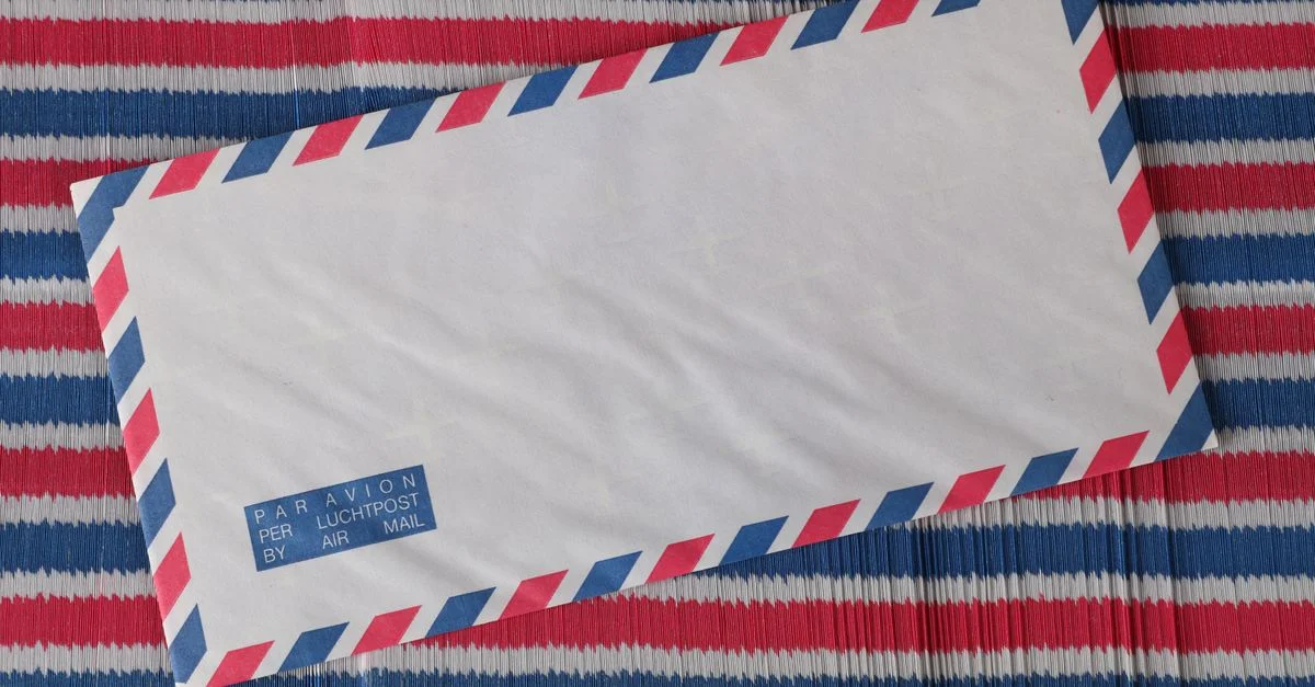 Enveloppe airmail avec des rayures rouges et bleues, parfaite pour des thèmes postaux ou des maquettes de papeterie.